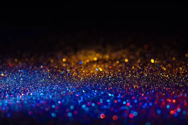 Veelkleurige glanzende glitter in focus en onscherp, abstracte glanzende achtergrond — Stockfoto