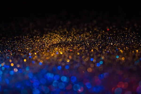 Veelkleurige glanzende glitter in focus en onscherp, abstracte glanzende achtergrond — Stockfoto