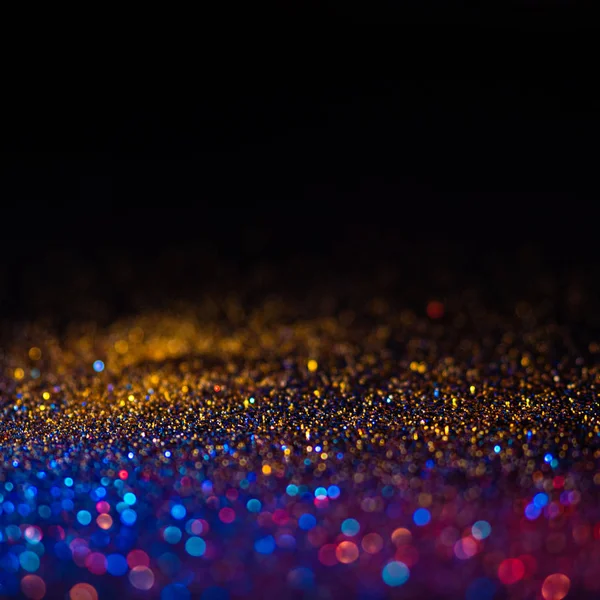 Veelkleurige glanzende glitter in focus en onscherp, abstracte glanzende achtergrond — Stockfoto