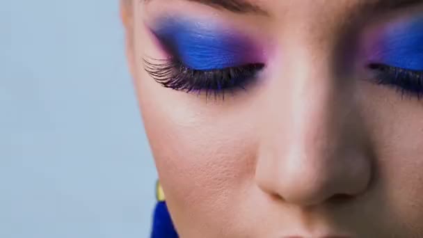 Maquillage des yeux lumineux glamour en utilisant la couleur tendance bleu classique, les yeux des femmes gros plan . — Video