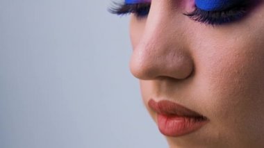 Klasik mavi rengini kullanarak göz kamaştırıcı parlak göz makyajı, kadınların yakın plan gözleri..