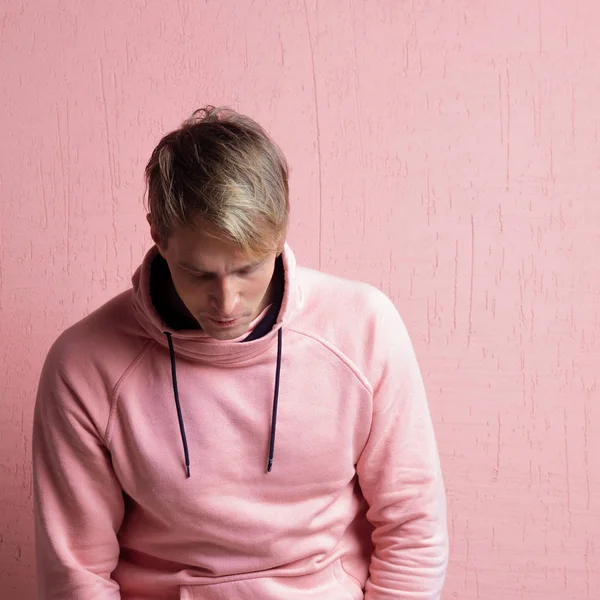 Young man in a pink hoodie hung his head and thought, a portrait — Stock Photo, Image