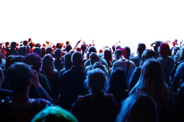 Crowd of fans at a concert in front of the stage, a lot of people look at the stage — Stok fotoğraf