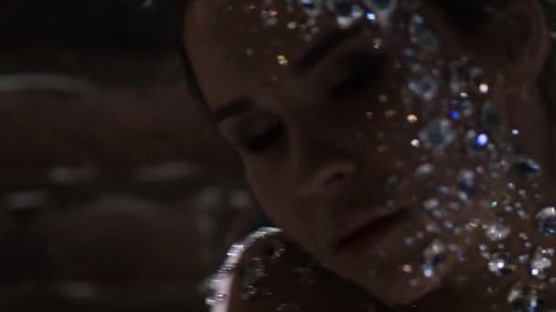 Fantastic fashion portrait of a young beautiful woman with transparent crystals — Stock Video