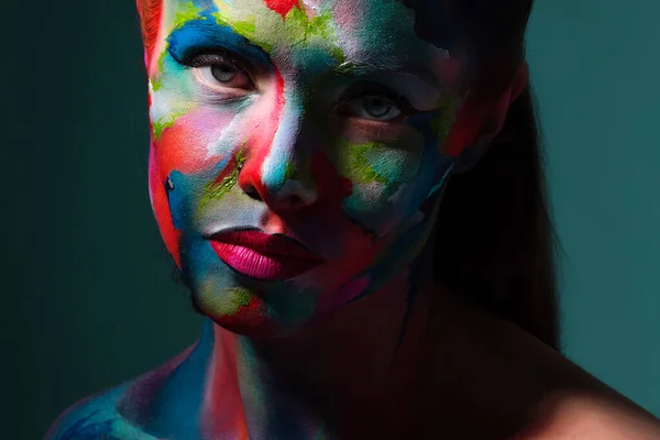 Multicolored skin, difficult to identify. Creative makeup and drawing on the face.