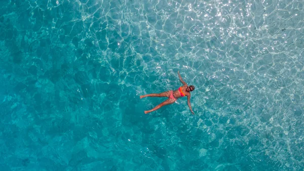 Aerial photo of girl in blue water of Indian ocean — Stock Photo, Image