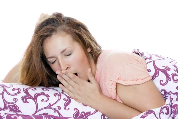 Young and beautiful woman in a bed just woke up and yawning. — Stock Photo, Image