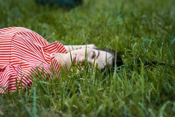 Girl lies on lawn — Stock Photo, Image