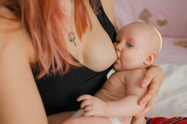 Young mom breastfeeding her newborn child. Lactation infant conc — 스톡 사진