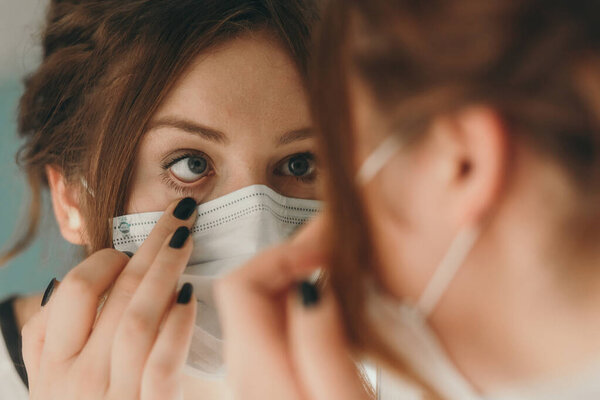 Woman checking her health condition looking into her eye, closeup portrait 