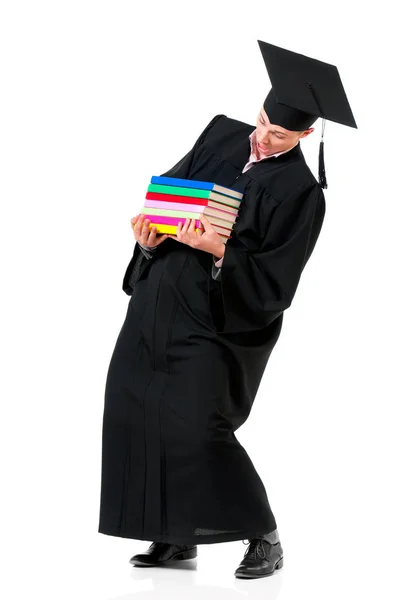 Hombre de graduación llevando libros pesados — Foto de Stock