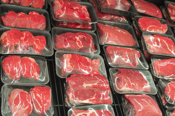 Variety of meat slices in boxes in supermarket