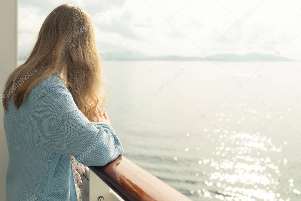 Cruise ship vacation. Teenager girl relaxing on luxury cruise ship balcony