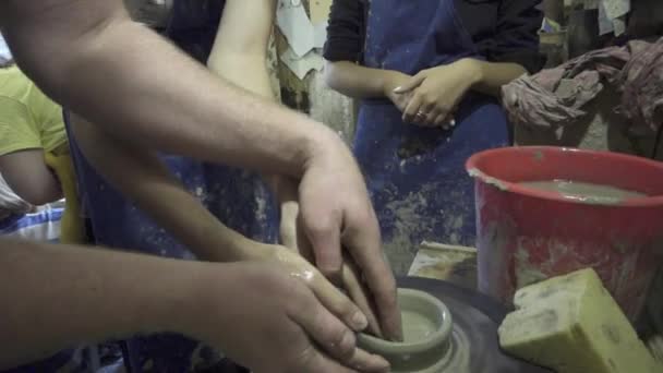 Il vasaio modella il prodotto in argilla con utensili in ceramica sulla ruota dei vasai, fabbrica artigianale autentica — Video Stock
