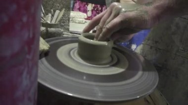 Kil yakın plan vazo oluşturuluyor. Atölyedeki heykeltıraş kilden sürahi yapıyor..