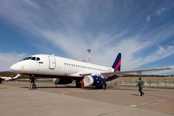 People looking at the aircraft  Sukhoi SuperJet 100-95