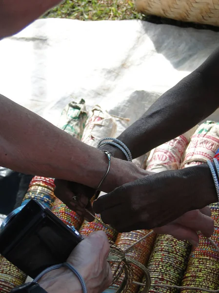 Western tourist traying on bangles