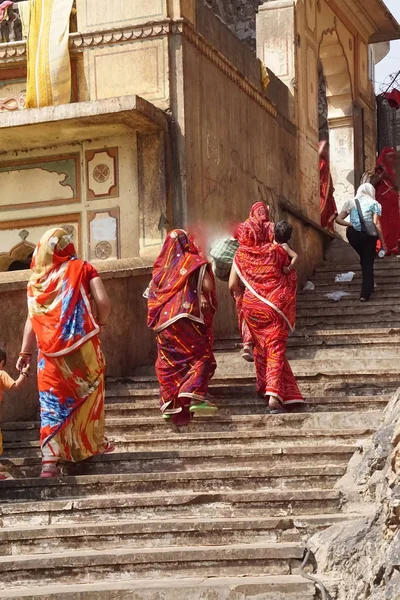 Hindu women climb the steps