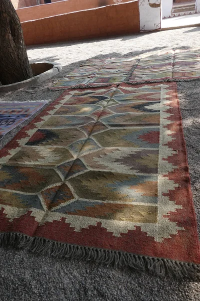 Local weaver displays dhurries,    thin flat-woven rug or carpet used traditionally in South Asia as floor-coverings. in a small village near Jodhpur, Rajasthan, India