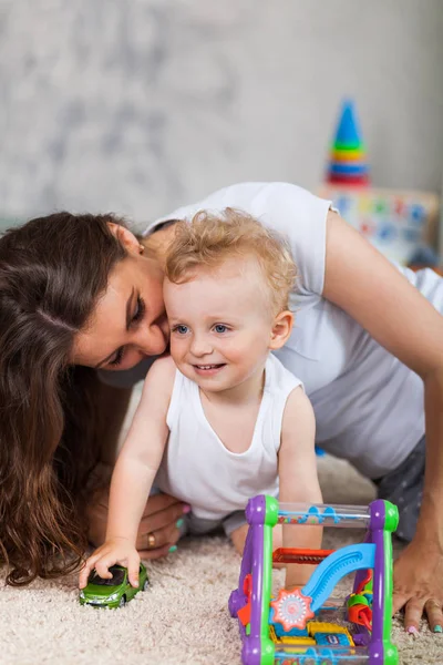 Madre y su hijo juegan juntos en interiores —  Fotos de Stock