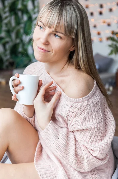 Beauty Portrait Relaxed Woman in the Morning and Drinks Coffee in Bed. Caucasian young woman Relaxed in Bed with cup of coffee