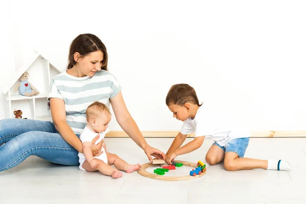 Mother Sitting With kids playing game Indoors — Stock Fotó