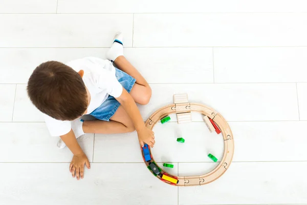 Little boy playing with toy train at home — Stock Photo, Image