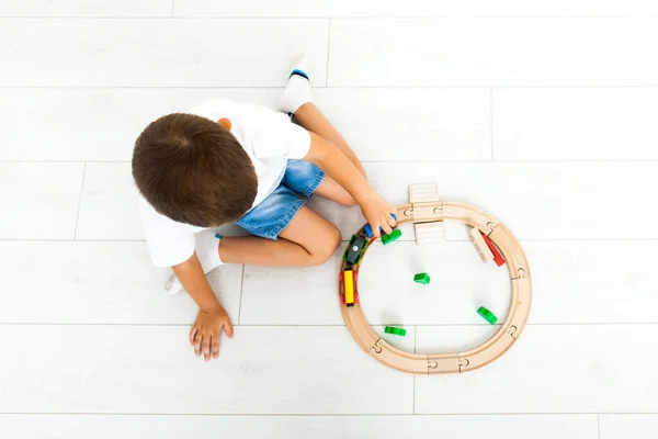 Little boy playing with toy train at home — Stock Photo, Image