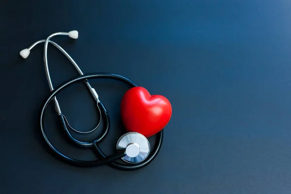Üst Düzey Aksesuar Düzlüğü doktor, sağlık ve tıbbi geçmiş konsepti için temel öğeler. Kırmızı kalp ve steteskop mavi arka planda fotokopi uzayı ile. Kalp kontrolü konsepti sağlık hizmetleri
