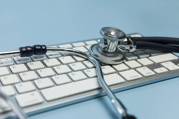 Stethoscope and computer keyboard. Computer technology is an integral part of medicine, healthcare, medical and health insurance today.