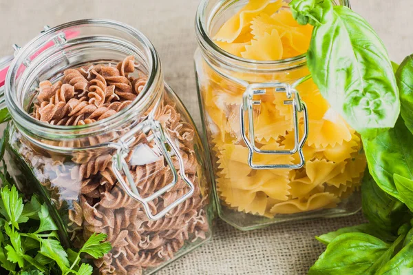 Close-up of farfalle and fusilli pasta in a jar