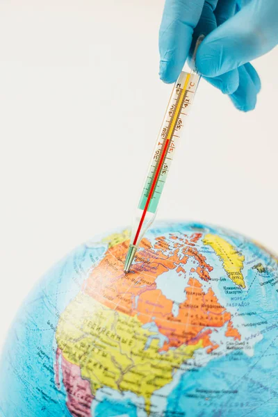 The thermometer measures the temperature of the planet earth - Virus epidemic in Canada - seasonal flu outbreak - high fever over 37 degrees - coronavirus pandemic