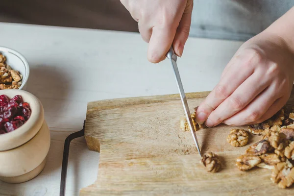 木木板上的核桃仁片 自制菜谱 家庭主妇的手 选择性焦点 — 图库照片