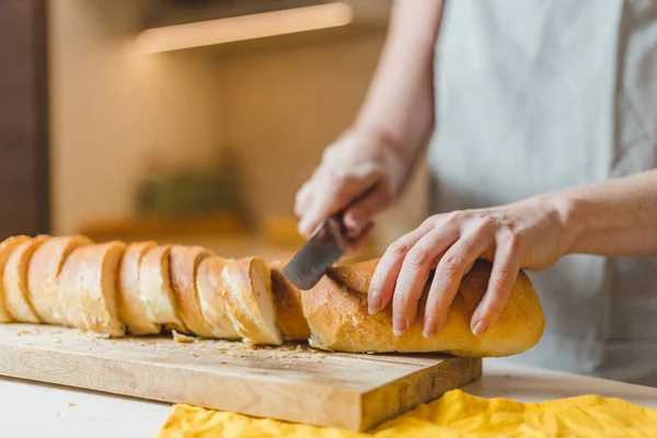 Closeup of housewife frying baguette pieces in a frying pan - making cold snacks - tapas and sandwiches