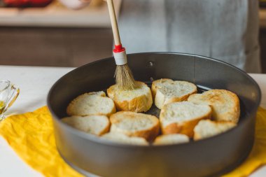 Kadın öğle yemeği hazırlıyor, ızgara ekmek sandviçi yapıyor ahşap kesim tahtasında bruschetta servis ediyor, yeşil salata, krem peynir, avokado - sağlıklı yiyecek.