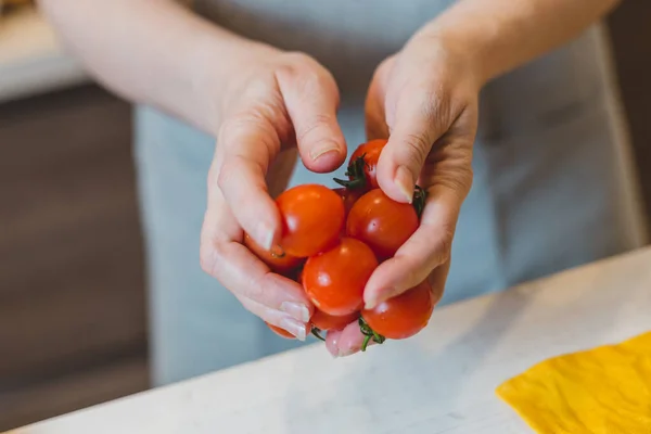 The cook chooses the best tomatoes for quality dishes and exclusive cuisine