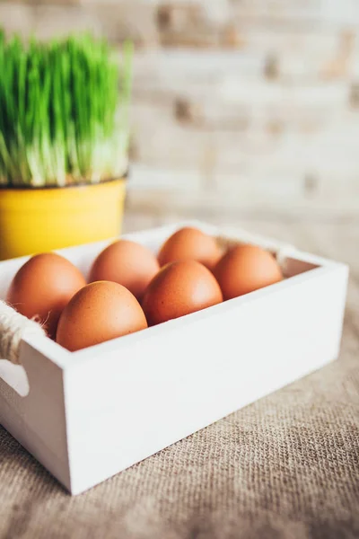 Chicken eggs in a white wooden box before Easter - Christian traditions