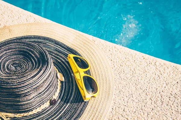 Sunglasses on the edge of the pool - the holiday season - rest and recovery