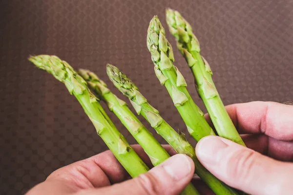 Close Man Holds Asparagus His Fingers Cook Chooses Quality Product — Stock Photo, Image