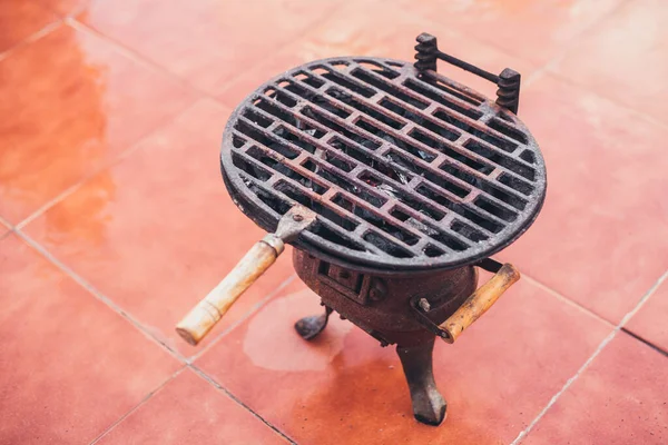 Portable home grill for small portions - cast iron grill over charcoal