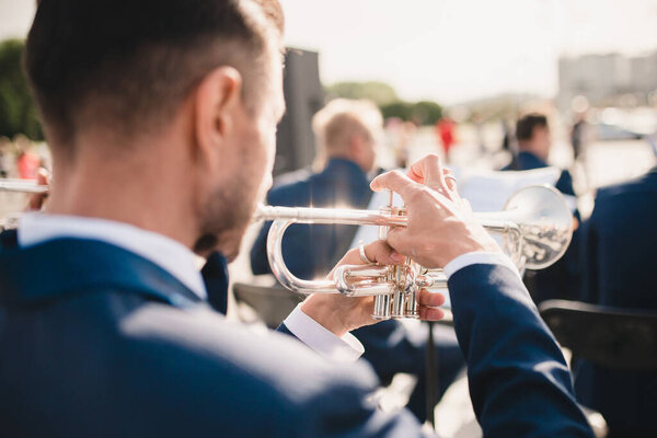 Rear view of an orchestra trumpeter - brass band musician - selective focus