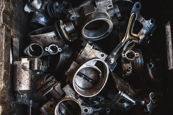Box of old auto parts in a car workshop - auto repair shop