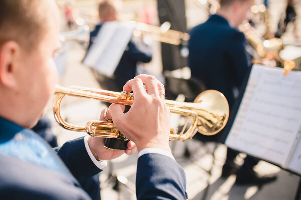 Trumpeter at a concert as part of an orchestra - rear view