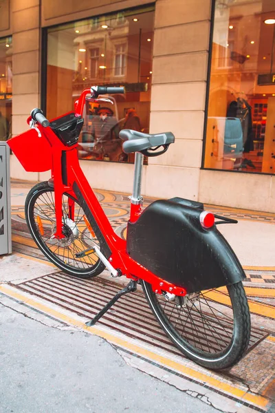 Red city electric bike on a city street - Paris cityscape