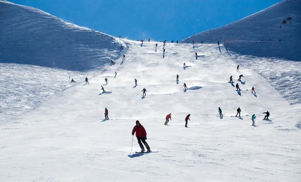 people skating on a ski slope