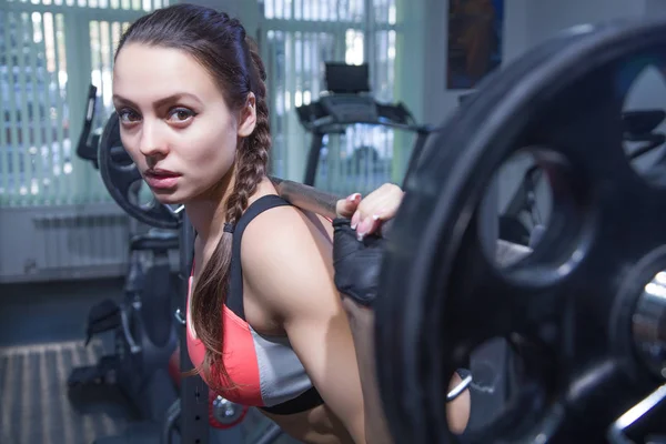 Young woman with barbell — Stock Photo, Image