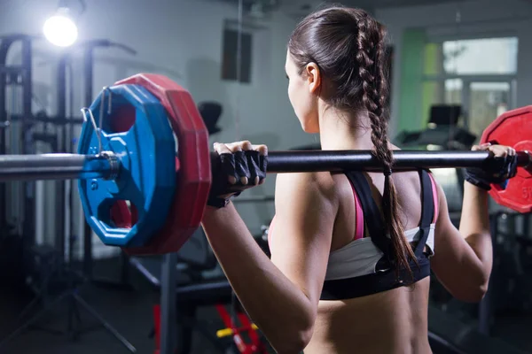 Young woman with barbell — Stock Photo, Image