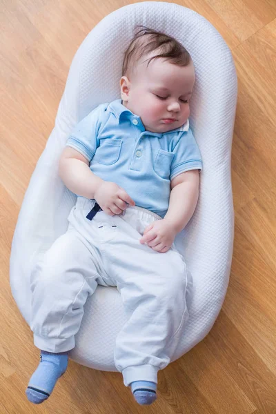 Little child lying in cradle — Stock Photo, Image