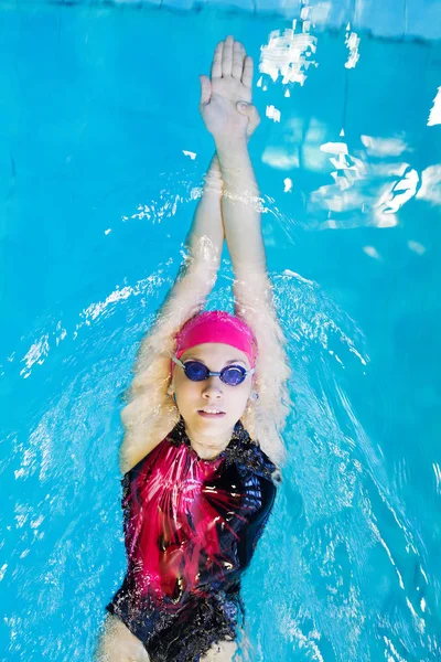 Zwemmende vrouw in het zwembad — Stockfoto