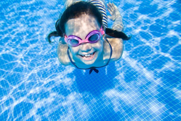 Маленькая девочка плавает в бассейне — стоковое фото